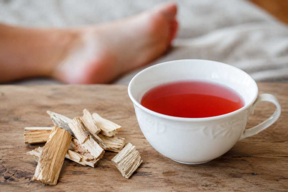 Bâtonnets d’aubier de tilleul bio près d’une casserole et d’une tasse de décoction après un repas festif